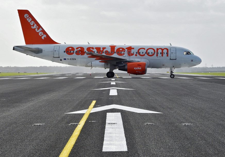 epa05297689 (FILE) A file photo dated 23 October 2015 showing an Airbus A319 of Easyjet crossing the redeveloped northern runway as it taxies to the start on the southern runway of the airfield at Sch ...