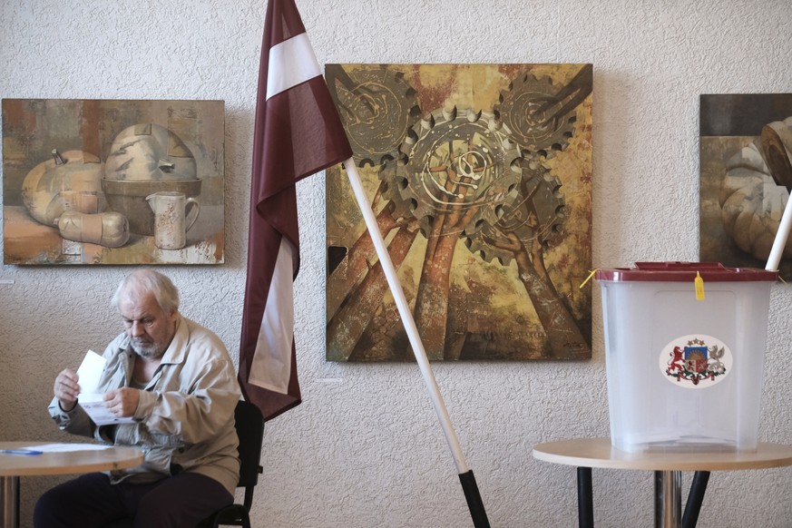 epa13278632 A man votes at a polling station during parliamentary elections to the 15th Saeima in Zvejniekciems, Latvia, 03 October 2026. Latvian voters cast their ballots across the nation to elect a ...