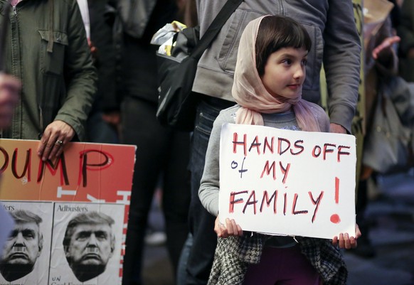 epa06254067 YEARENDER 2017 JANUARY 
Rosalie Gurna, nine, joins hundreds of protesters denouncing the travel ban from Muslim-majority countries enacted by US President Donald Trump outside of the inter ...