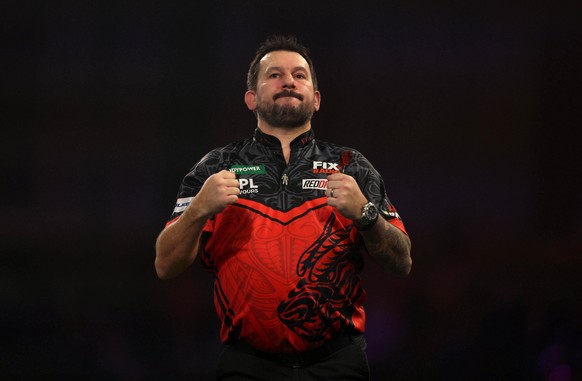 Wales' Jonny Clayton celebrates defeating Sweden's Andreas Harrysson on day seventeen of the World Darts Championship at the Alexandra Palace in London, Tuesday Dec. 30, 2025. (Steven Paston ...