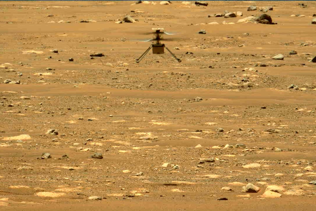 FILE - In this image made available by NASA, the Mars Ingenuity helicopter hovers above the surface of the planet during its second flight on April 22, 2021. On Thursday, Jan. 25, 2024, NASA announced ...