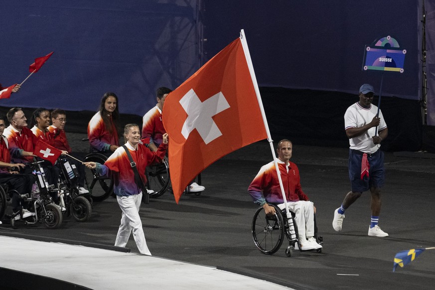 Switzerland&#039;s flag-bearers Elena Kratter and Marcel Hug celebrate with Swiss athletes during the opening ceremony of the 2024 Paris Summer Paralympics Games in Paris, France, Wednesday, August 28 ...