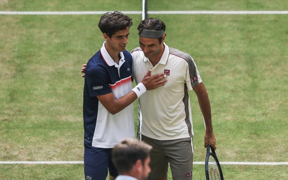 Pierre-Hugues Herbert, left, of France, congratulates Roger Federer on his victory after their semifinal of the Halle Open tennis tournament in Halle, Germany, Saturday, June 22, 2019. (Friso Gentsch/ ...