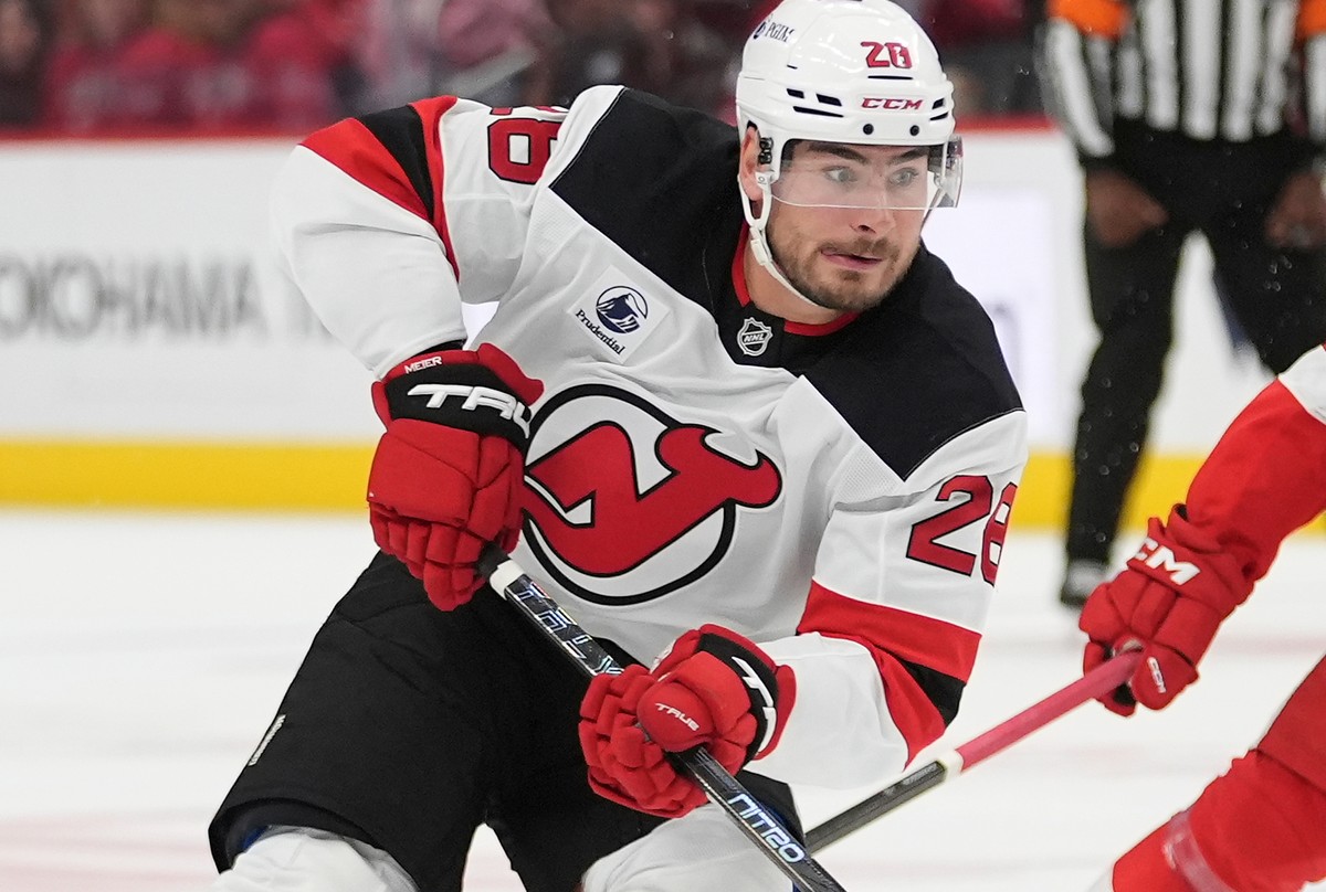 New Jersey Devils right wing Timo Meier (28) carries the puck as Detroit Red Wings defenseman Albert Johansson (20) defends in the third period of an NHL hockey game Tuesday, Oct. 13, 2026, in Detroit ...