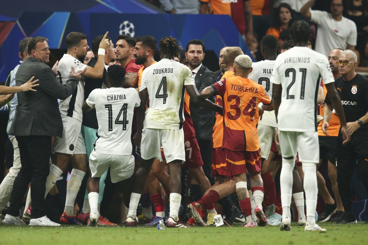 epa11567861 YB's head coach Patrick Rahmen (L), Galatasaray head Irfan Saraloglu (R) and players from both team interact during the UEFA Champions League play-off second leg soccer match between ...