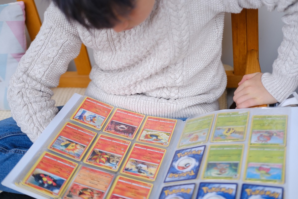 positive child collecting Pokemon Trading Card Game, collectible card game for children, Battle with friends, Educational Games, Pokemon Fan Culture, Frankfurt - October, 28, 2023 xkwx Pokemon Card pl ...