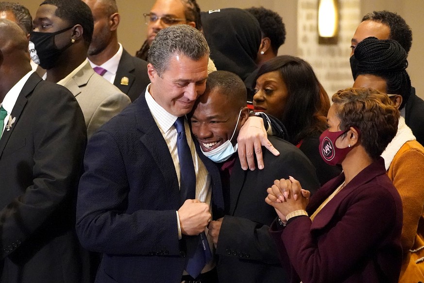 Attorney Tony Romanucci, center left, hugs Donald Williams, a key witness in the trial of former Minneapolis police Officer Derek Chauvin, during a news conference after the guilty verdict was read, T ...