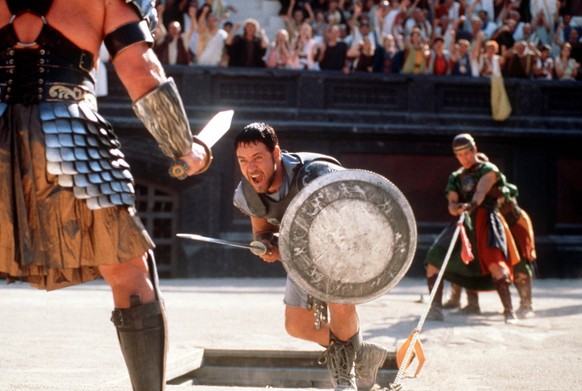 Russell Crowe center fights a gladiator in his role as Roman general Maximus, in this handout photo from Universal's film &quot;Gladiator,&quot; directed by Ridley Scott. Colleagues say the 36-year ol ...
