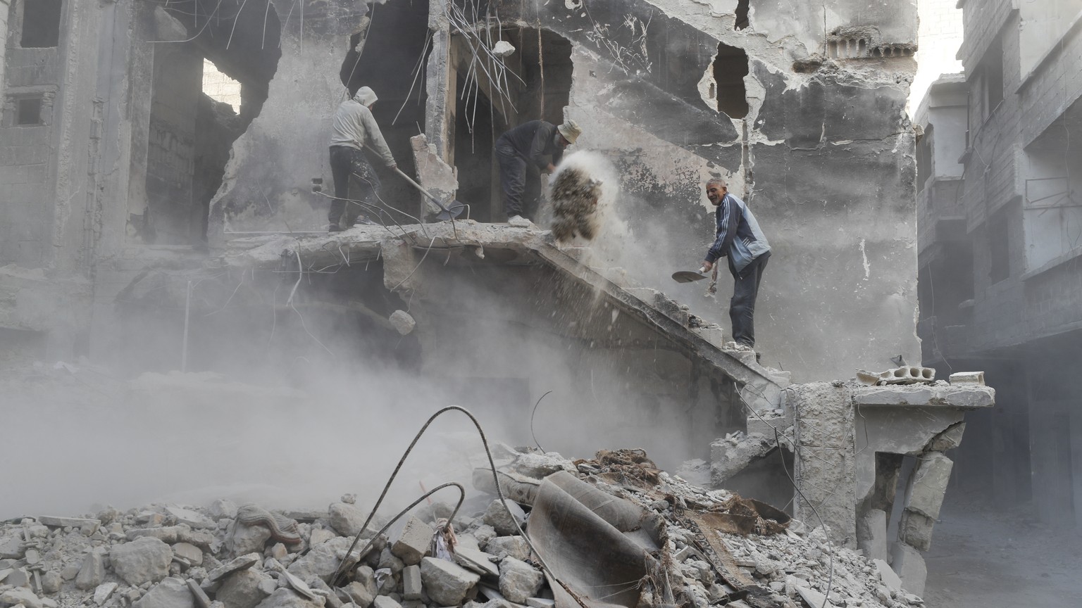 File - Workers clean up destruction h Yarmouk camp in Damascus Syria that has seen heavy fighting during the civil war, Wednesday, Nov. 2, 2022. A trickle of residents has returned to Yarmouk, the lar ...