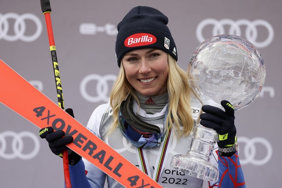 FILE - Mikaela Shiffrin celebrates on the podium with the trophy for the alpine ski women&#039;s overall World Cup title, in Meribel, France, Sunday, March 20, 2022. Shiffrin heads into the World Cup  ...
