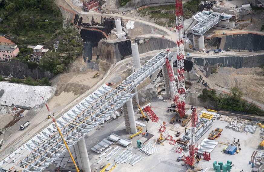 epa08369518 An aerial view of the new Genoa motorway bridge construction site, in Genoa, northern Italy, 17 April 2020. The new bridge is under construction after the Morandi highway bridge partially  ...