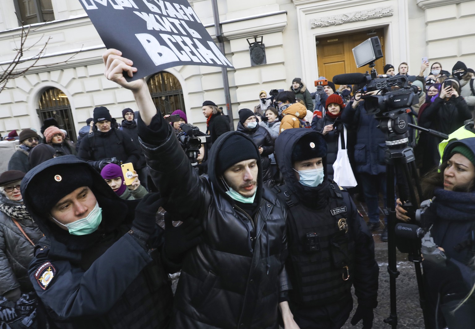 Police officers detain a demonstrator as people gather in front of the Supreme Court of the Russian Federation, in Moscow, Russia, Tuesday, Dec. 28, 2021. Russia���s Supreme Court has ruled that one o ...