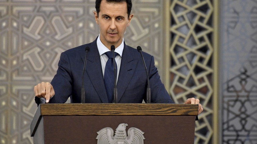 FILE - In this Aug. 20, 2017, file photo, released by the official Facebook page of the Syrian Presidency, Syrian President Bashar Assad speaks to Syrian diplomats, in Damascus, Syria. Assad&#039;s re ...