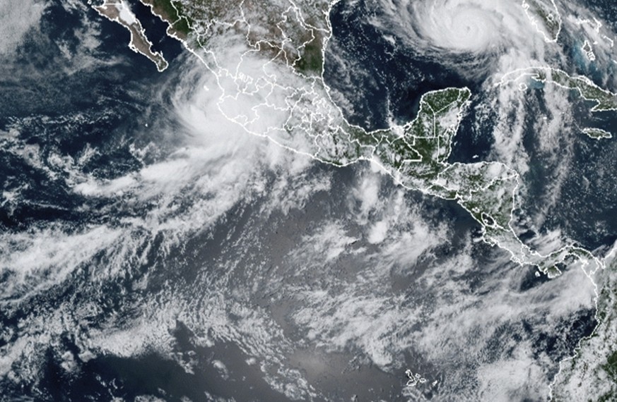 This image provided by the National Oceanic and Atmospheric Administration (NOAA) shows severe weather systems, Hurricane Nora, upper left, and Hurricane Ida, upper right, over the North American cont ...