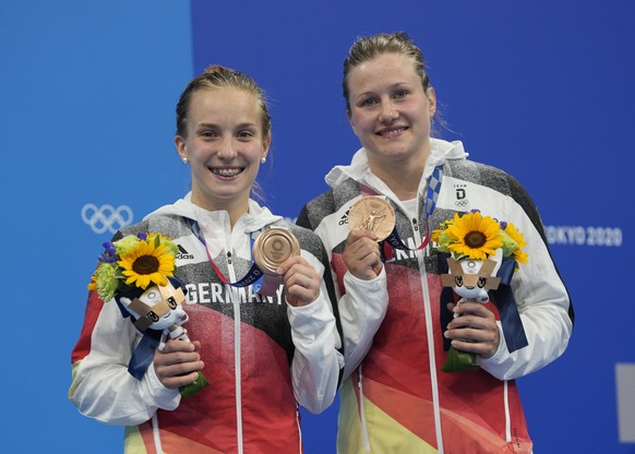 Lena Hentschel and Tina Punzel of Germany pose for a photo after winning bronze medals during the Women&#039;s Synchronized 3m Springboard Final at the Tokyo Aquatics Centre at the 2020 Summer Olympic ...