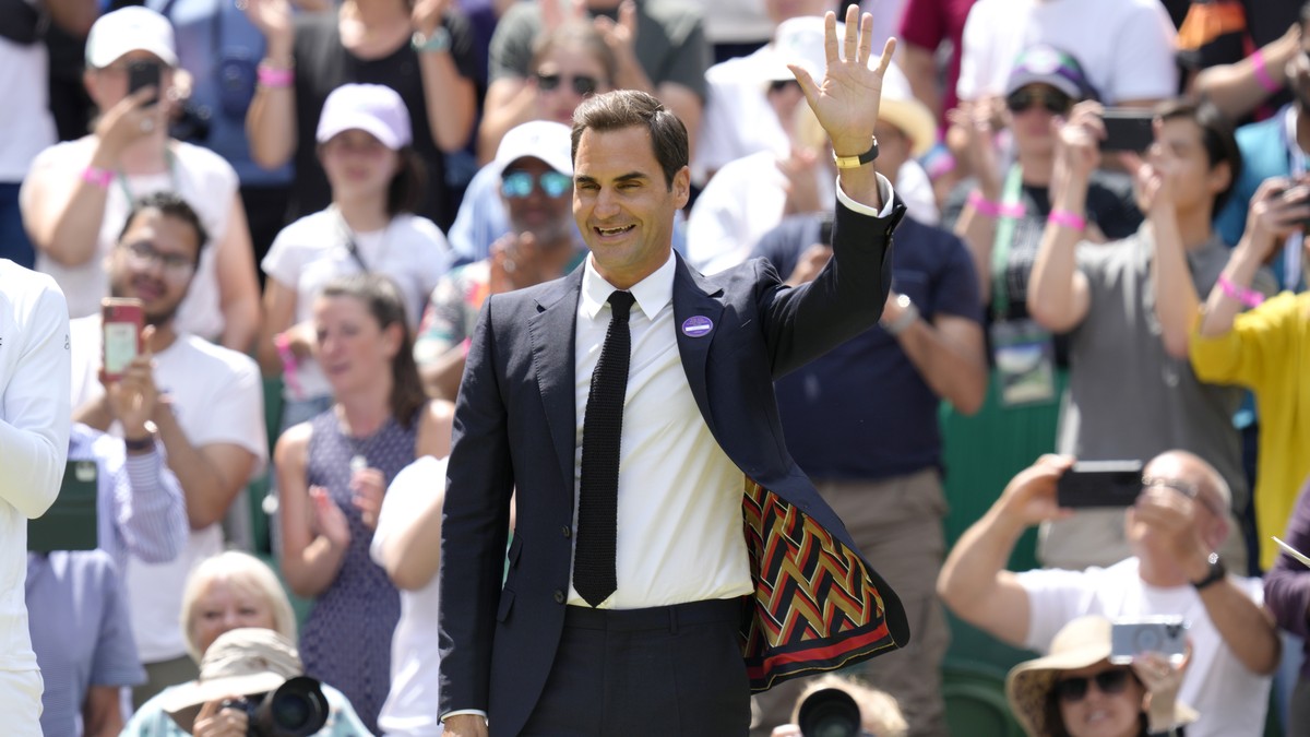 Switzerland's Roger Federer waves during a 100 years of Centre Court celebration on day seven of the Wimbledon tennis championships in London, Sunday, July 3, 2022. (AP Photo/Kirsty Wigglesworth)