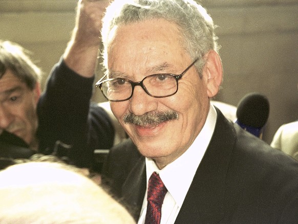 FILE - Former Algerian Defense Minister and retired Gen. Khaled Nezzar smiles as he answers reporters at the Paris courthouse Monday, July 1, 2002. Swiss federal prosecutors said Tuesday they have ind ...