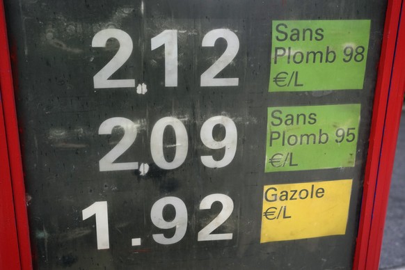 The per-liter prices for gasoline and diesel fuel are displayed in front of a filling station, (2.12 Euros equivalent to 2.47 US dollar), in Paris, France, Thursday, Oct. 21, 2021. France&#039;s gover ...