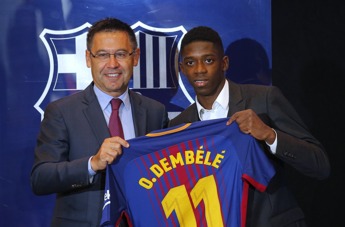 Barcelona's new signing player Ousmane Dembele, right, and FC Barcelona's president Josep Maria Bartomeu pose for the media during official presentation at the Camp Nou stadium in Barcelona, ...