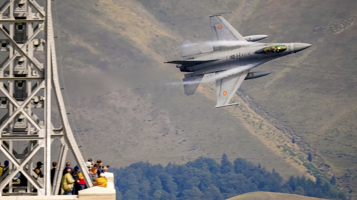 An F-16 Falcon Romanian aircraft flies by during a show of military and acrobatic aviation near the Heroes Cross on Caraiman Peak on top of Bucegi mountains, in Busteni, Romania, Tuesday, Aug. 26, 202 ...
