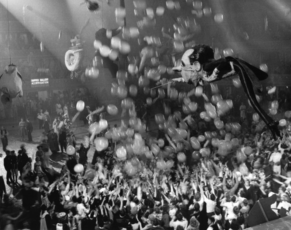 A huge caricature of conductor Sir Malcolm Sargent floating above the crowd of New Year revellers at the Chelsea Arts Ball. (Photo by Keystone/Getty Images)