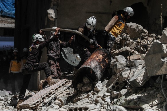 epa06775628 Syrian firefighters and civil defense personnel work at the site of explosion at a building in the town of Ariha, Idlib province, Syria, 31 May 2018. According to local reports, three peop ...