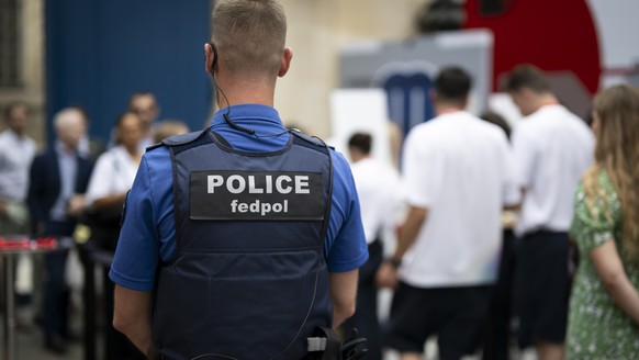 A policeman of the Federal Police Fedpol supervises the entrance of guests prior to the opening ceremony of the Maison Suisse in the Swiss Embassy in Paris, prior to the 2024 Paris Summer Olympics in  ...