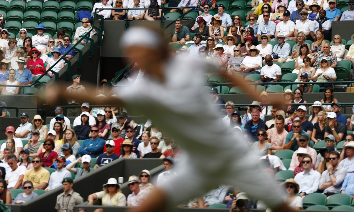 epa07687514 Spectators watch Alexander Zverev of Germany return to Jiri Vesely of the Czech Republic in their first round match during the Wimbledon Championships at the All England Lawn Tennis Club,  ...