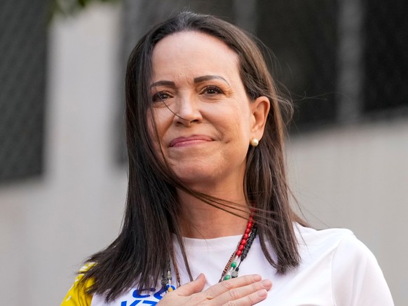 FILE - Opposition leader Maria Corina Machado gestures to supporters during a protest against President Nicolas Maduro the day before his inauguration for a third term, in Caracas, Venezuela, Thursday ...