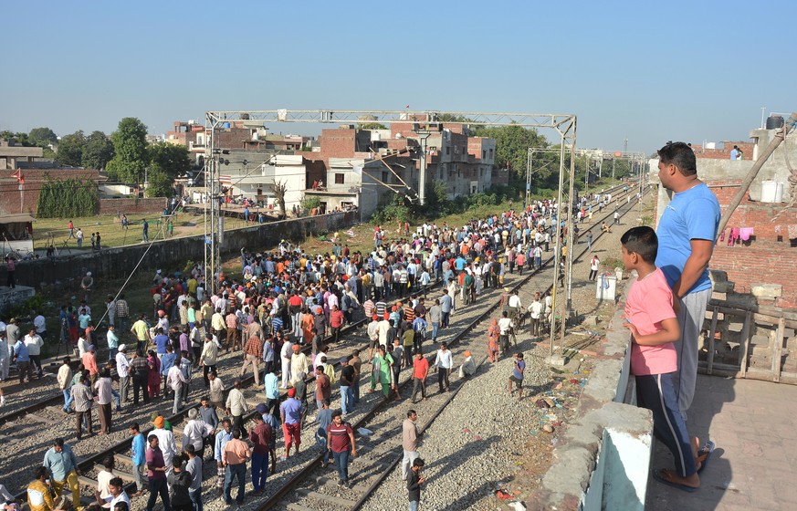 A crowd gathers at the site of Friday&#039;s train accident in Amritsar, India, Saturday, Oct. 20, 2018. A speeding train ran over a crowd watching fireworks during a religious festival in northern In ...
