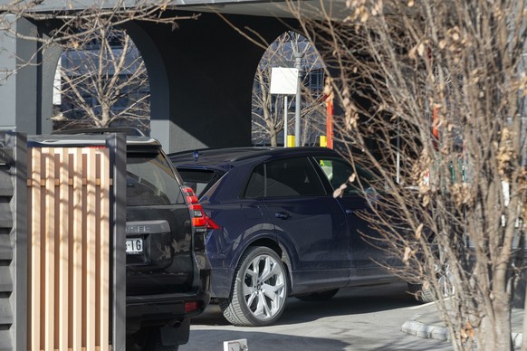 A dark blue vehicle taking Novak Djokovic, unseen, at an apartment complex in Belgrade, Serbia, Monday, Jan. 17, 2022. Djokovic arrived in his native Serbia on Monday after being deported from Austral ...