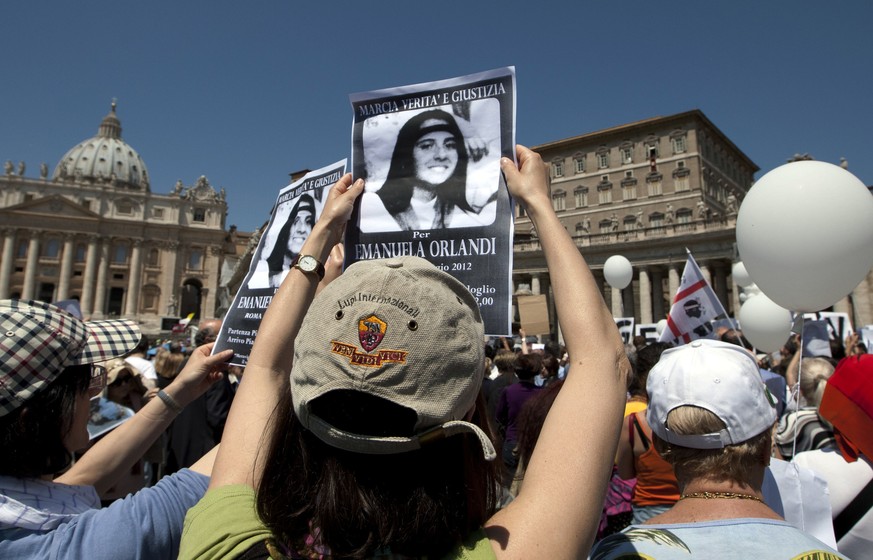FILE - In this May 27, 2012 file photo, protesters hold pictures of Emanuela Orlandi reading "march for truth and justice for Emanuela" during Pope Benedict XVI's Regina Coeli prayer...