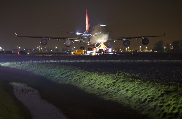 A self-propelled trailer transports a Boeing 747-400 plane through farmland from Schiphol Airport to a nearby hotel in Badhoevedorp, near Amsterdam, Netherlands, Wednesday, Feb. 6, 2019. The Boeing is ...