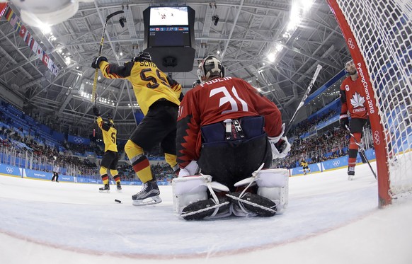 Patrick Hager (50), of Germany, celebrates after scoring a goal against goalie Kevin Poulin (31), of Canada, during the second period of the semifinal round of the men&#039;s hockey game at the 2018 W ...