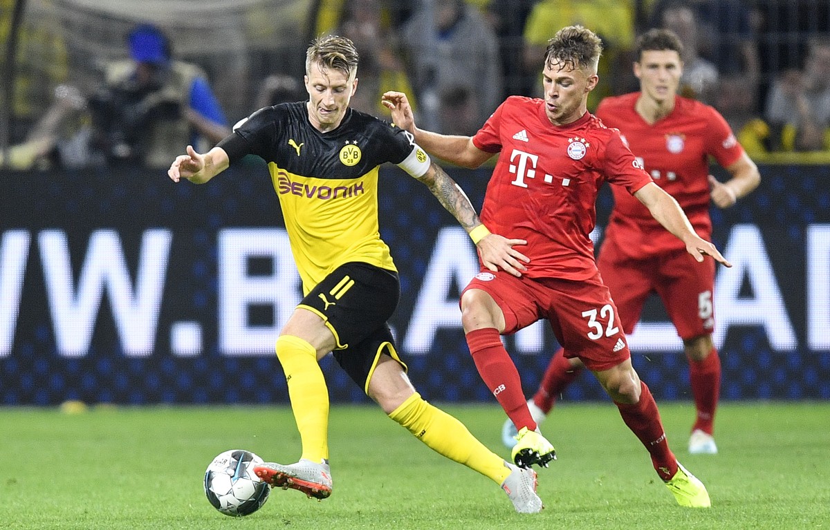 Dortmund's Marco Reus, left, and Bayern's Joshua Kimmich challenge for the ball during the German Super Cup soccer match between Borussia Dortmund and Bayern Munich in Dortmund, Germany, Sat ...