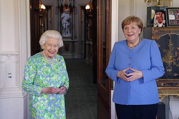 Britain&#039;s Queen Elizabeth receives the Chancellor of Germany Angela Merkel during an audience at Windsor Castle in Berkshire, England, Friday, July 2, 2021. (Steve Parsons/Pool Photo via AP)