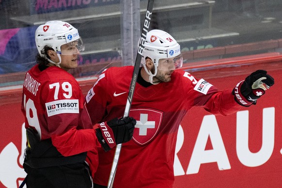 Switzerland&#039;s Calvin Thuerkauf, left, and Christian Marti celebrate the goal to 2-1 during the Ice Hockey World Championship group A preliminary round match between Switzerland and Slovakia in He ...