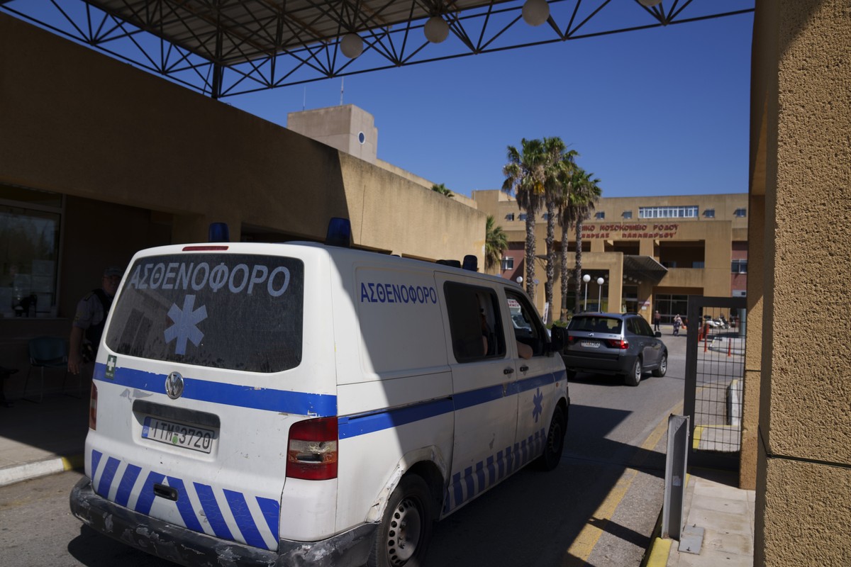 An ambulance drives through the entrance of a state-run hospital on the island of Rhodes, where the body of British TV presenter Michael Mosley was taken following his death while on vacation on the n ...