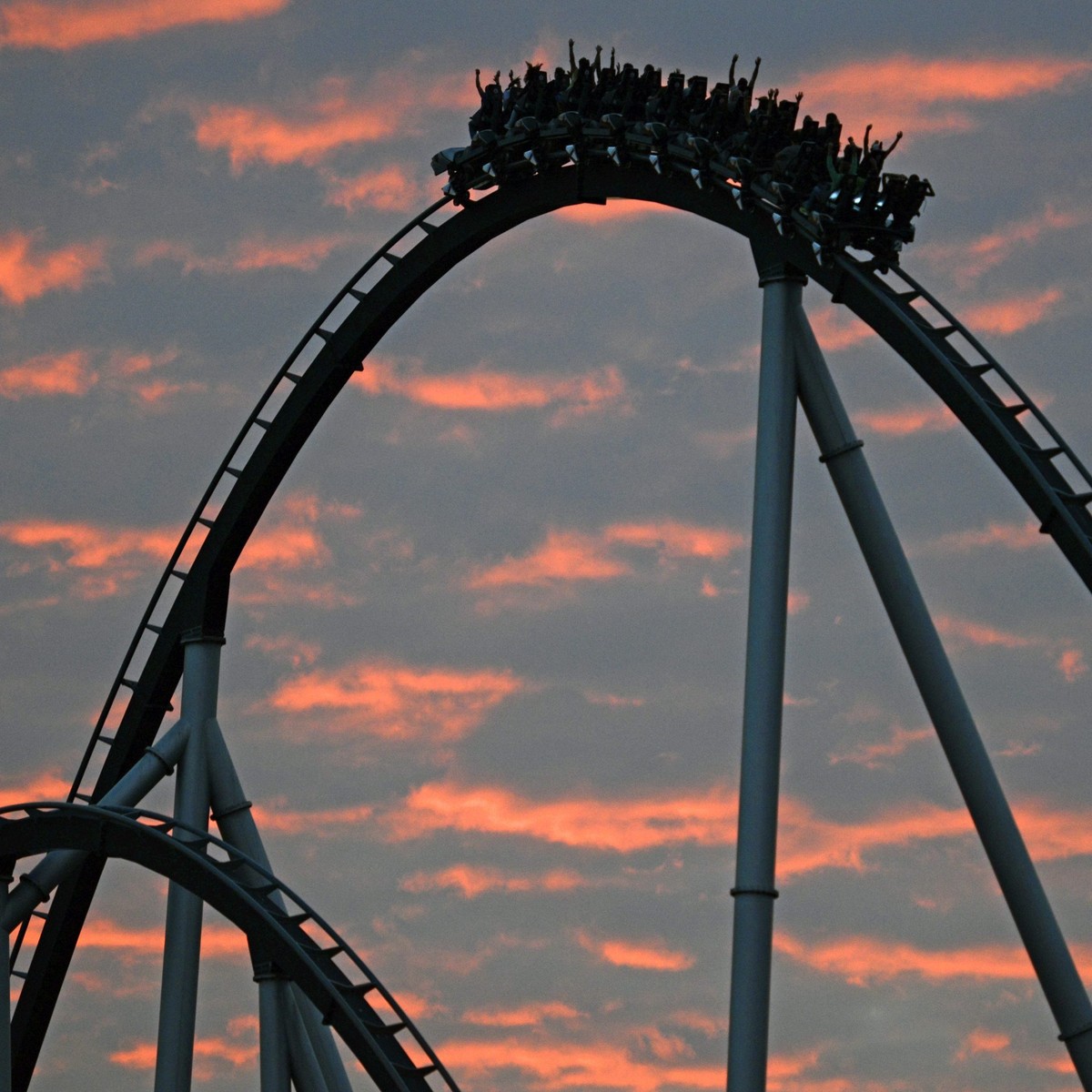 epaselect epa04385303 Visitors take a ride on the rollercoaster 'Silver Star' as the sun sets in the background at the Europa Park, in Rust, Germany, 04 September 2014. EPA/PATRICK SEEGER