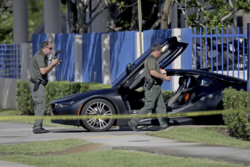 Investigators surround a vehicle after rapper XXXTentacion was shot on Monday, June 18, 2018, in Deerfield Beach, Fla. The Broward Sheriff&#039;s Office says the 20-year-old rising star was pronounced ...