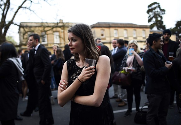 Students and revellers listen to the Magdelen College Choir sing from a spire overlooking the City in the early hours during traditional May Day celebrations in Oxford, Britain, May 1, 2015. REUTERS/D ...