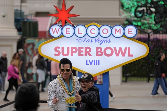 A San Francisco 49ers fan has his photo taken with an Elvis impersonator in front of a Super Bowl 58 sign at Caesars Palace Friday, Feb. 9, 2024 in Las Vegas. The Kansas City Chiefs will play the NFL  ...