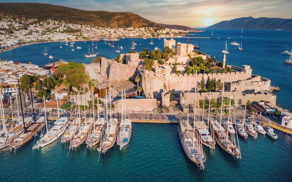 Sunset in yacht port at Castle. Yachting sunset scene. Yachts in sunset bay. Castle of St. Peter Bodrum Marina, sailing boats and yachts in Bodrum, Turkey; Shutterstock ID 2076439384; purchase_order:  ...