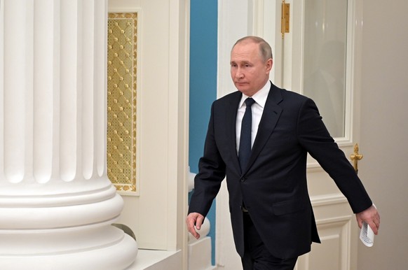 epa09781641 Russian President Vladimir Putin enters a hall on his way to a meeting with Russian businessmen at the Kremlin in Moscow, Russia, 24 February 2022. In the early hours of 24 February, Presi ...