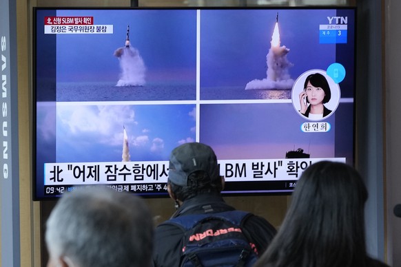 People watch a TV screen showing images of North Korea&#039;s ballistic missile launched from a submarine during a news program at Seoul Railway Station in Seoul, South Korea, Wednesday, Oct. 20, 2021 ...