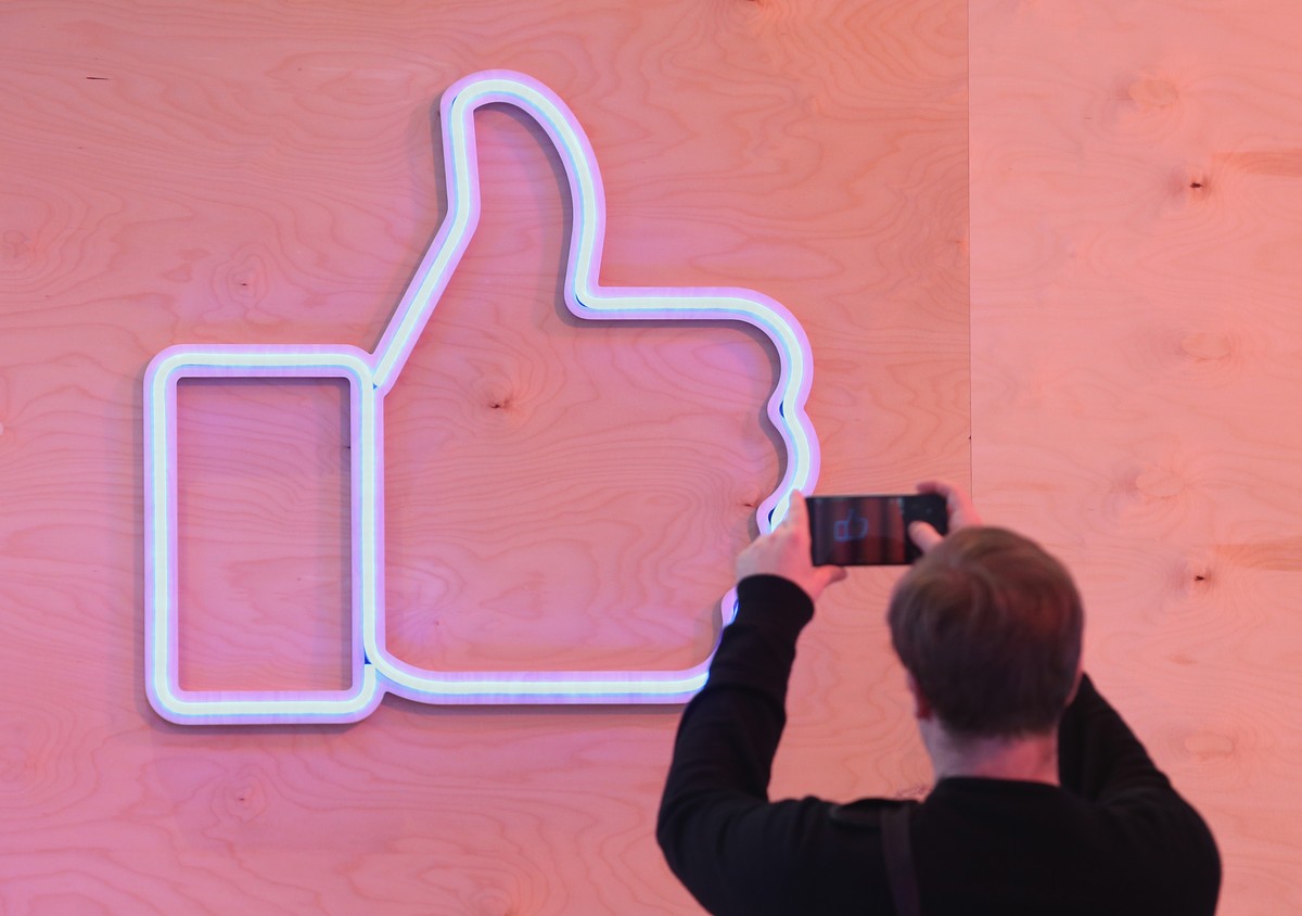 BERLIN, GERMANY - FEBRUARY 24: A visitor snaps a photo of the Facebook "Like" symbol at the Facebook Innovation Hub on February 24, 2016 in Berlin, Germany. The Facebook Innovation Hub is a  ...