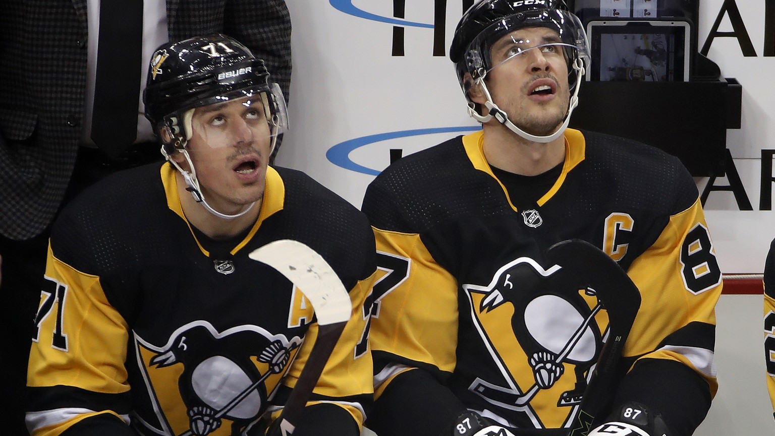 FILE - Pittsburgh Penguins' Evgeni Malkin (71) and Sidney Crosby (87) watch a replay of a goal by Malkin during the first period of the team's NHL hockey game against the Minnesota Wild in P ...