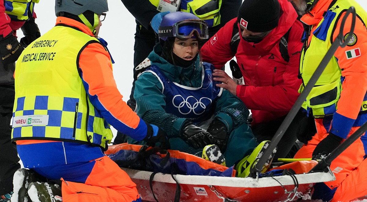 Medics tend to Switzerland's Mathilde Gremaud after she crashed during practice before the women's freestyle skiing big air finals at the 2026 Winter Olympics, in Livigno, Italy, Monday, Feb ...