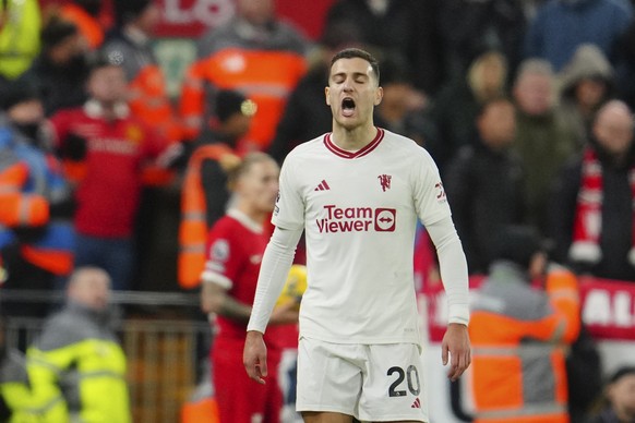 Manchester United&#039;s Diogo Dalot reacts after receiving a red card during the English Premier League soccer match between Liverpool and Manchester United at the Anfield stadium in Liverpool, Engla ...