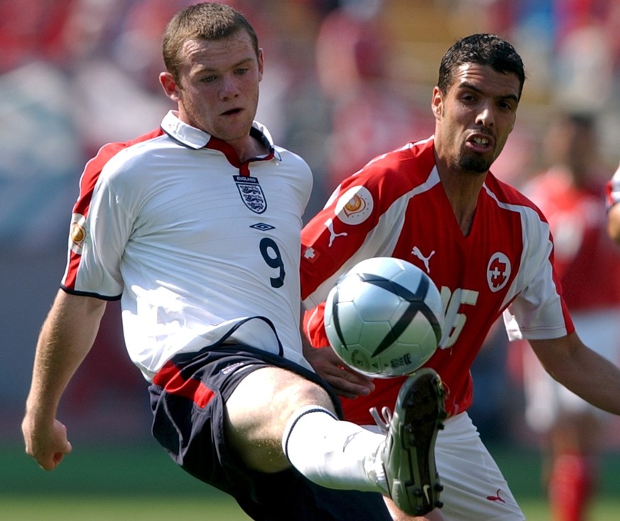 Switzerland&#039;s Fabio Celestini, right, fights for the ball with England&#039;s Wayne Rooney, left, during their Group B Euro 2004 first round match at the Cidade de Coimbra stadium in Coimbra, Por ...